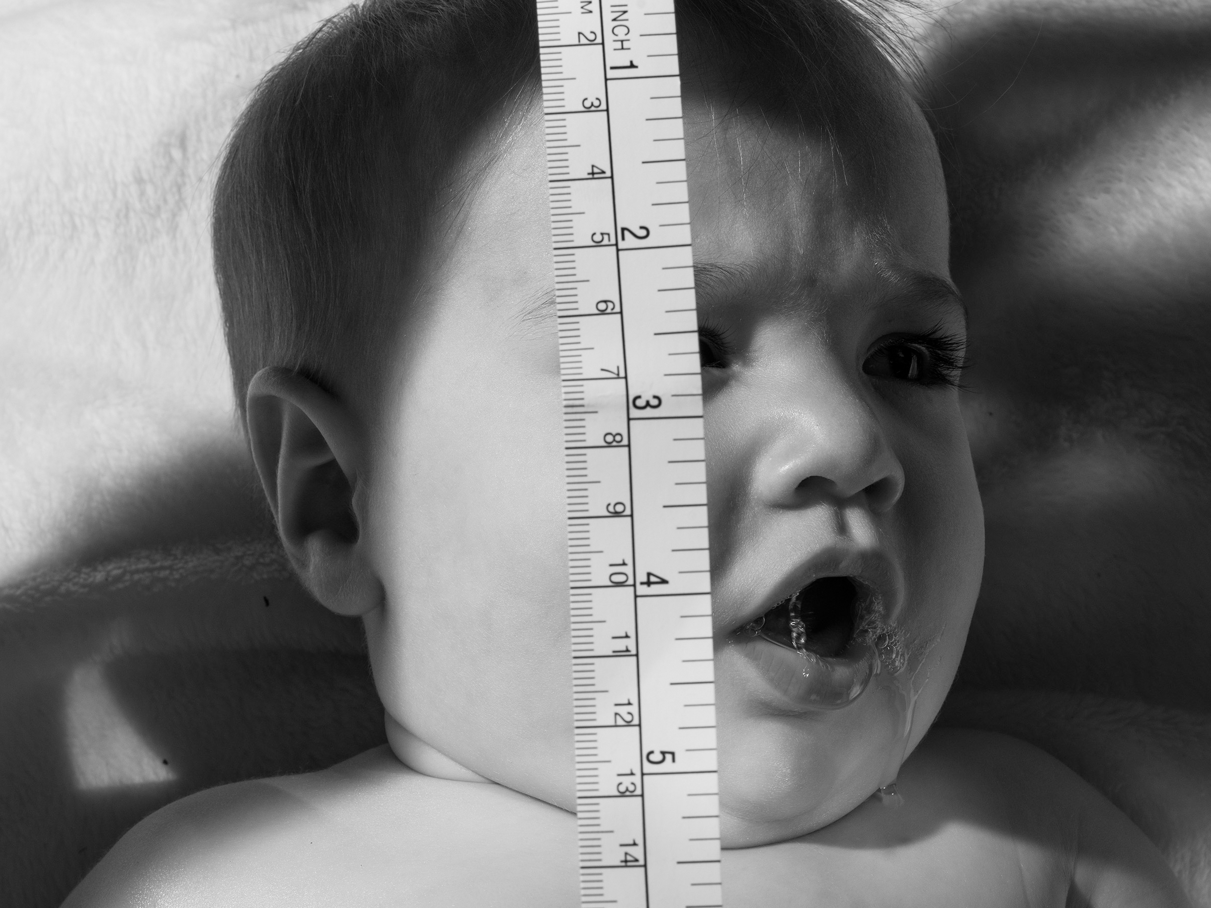 baby with tape measure